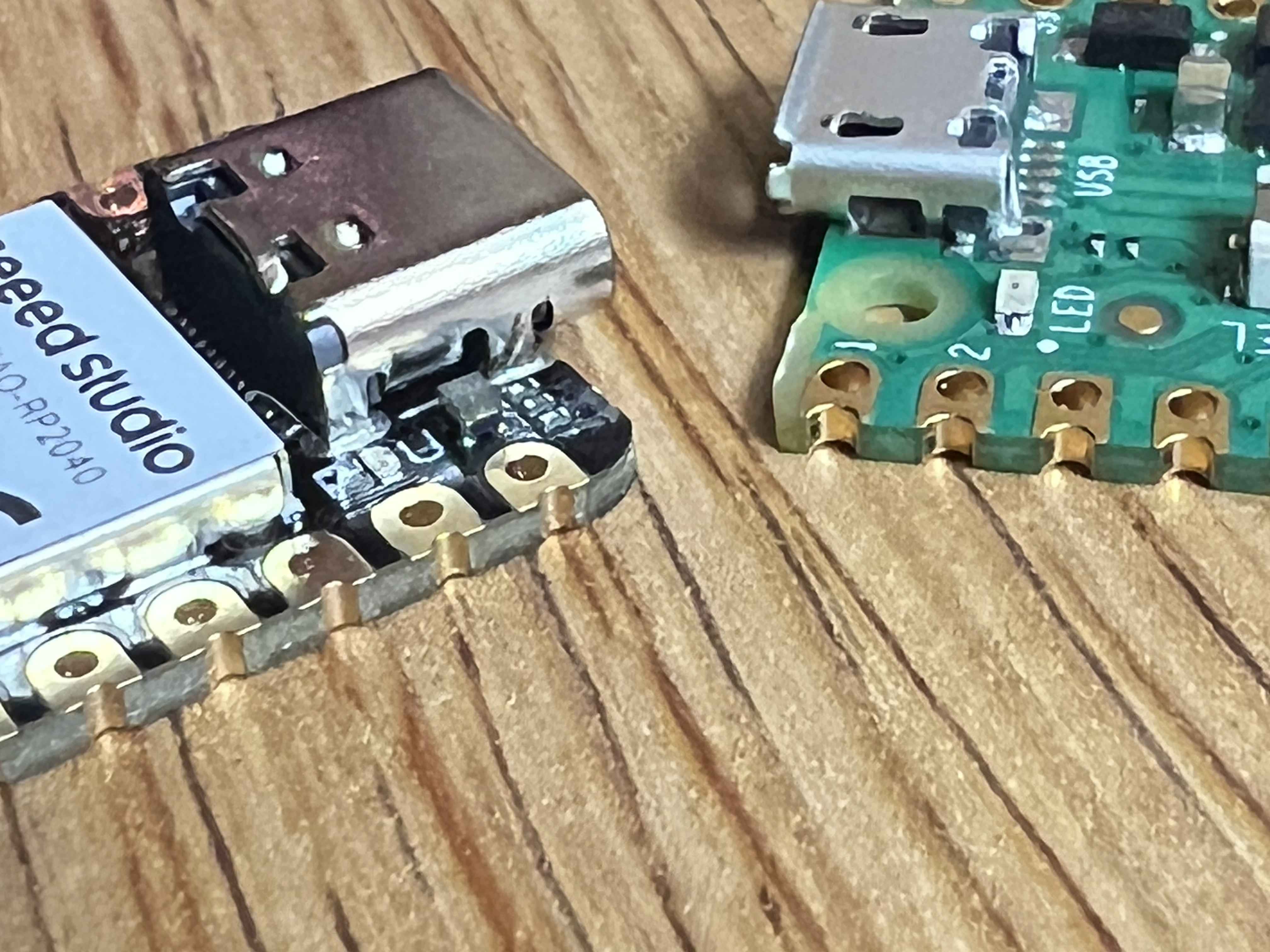 The castellated edges of a Raspberry Pi Pico and Seeed Studio XIAO